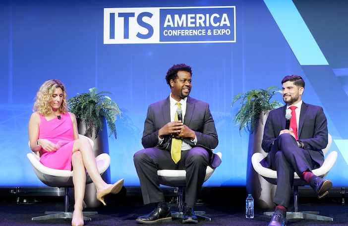 Robert Hampshere (center) speaking at ITS America 2023
