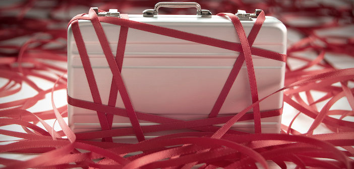 Red tape around a briefcase