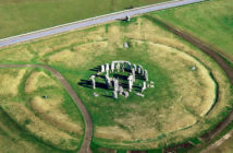 Stonehenge prehistoric stone circle, Wiltshire, England. Looking N.E. the A344 road intersects 'The Avenue' at the Heel Stone.