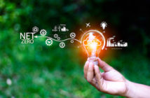Net zero concept. Hand holding bulb with net zero icon. It is surrounded by a clean energy icon. Net zero 2050. Carbon gas affects global warming. Concept with innovation inspiration from big data.