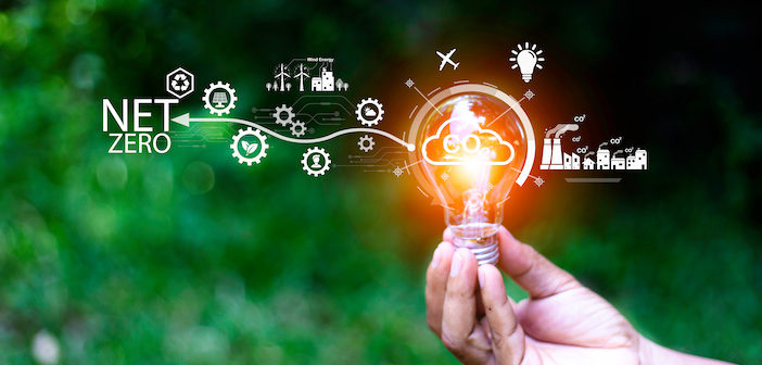 Net zero concept. Hand holding bulb with net zero icon. It is surrounded by a clean energy icon. Net zero 2050. Carbon gas affects global warming. Concept with innovation inspiration from big data.