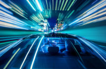 Moving forward, heading for the citylife, sitting in the backseat of a car while the cabdriver drives through a tunnel